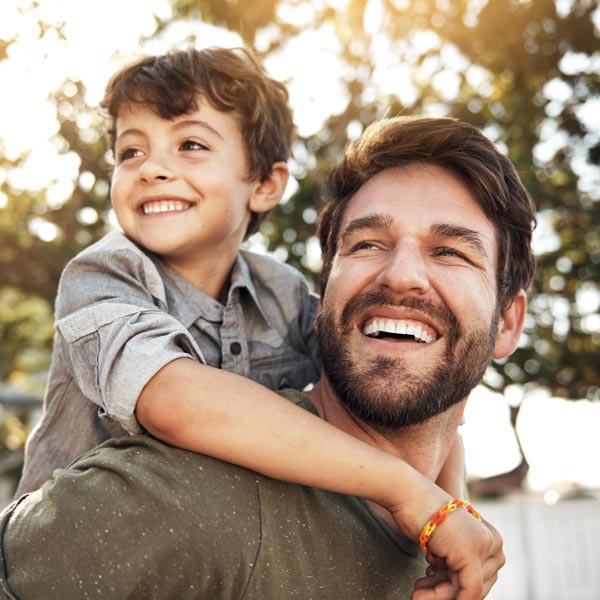 smiling father and son